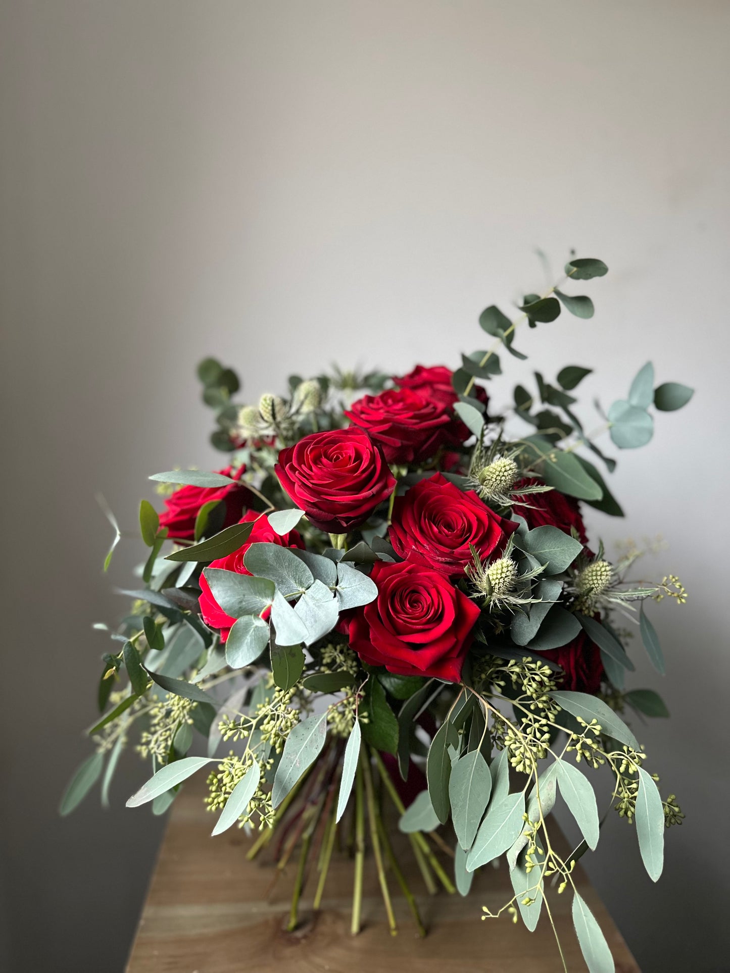 12 Red Roses (With extra foliage)